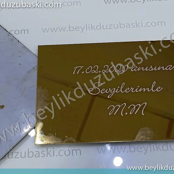 ayna gibi, çelik, parlak, metal üzerine, lazer ile baskı yapılmıştır, ürünleri müşteri getirir, baskıları bekler, alır